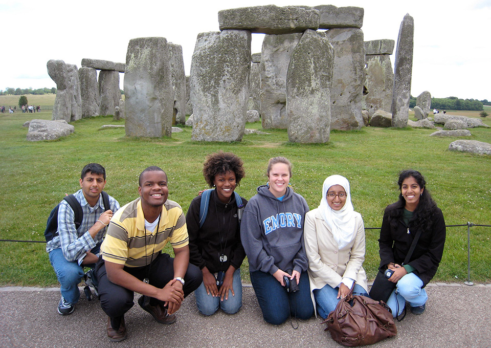students in front of Stonehenge monoliths