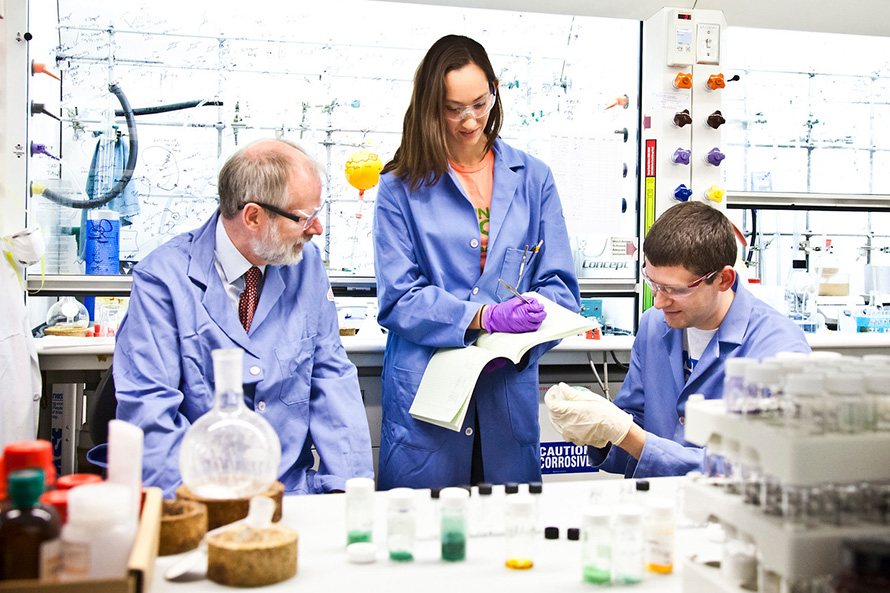 students and faculty in a chemistry lab