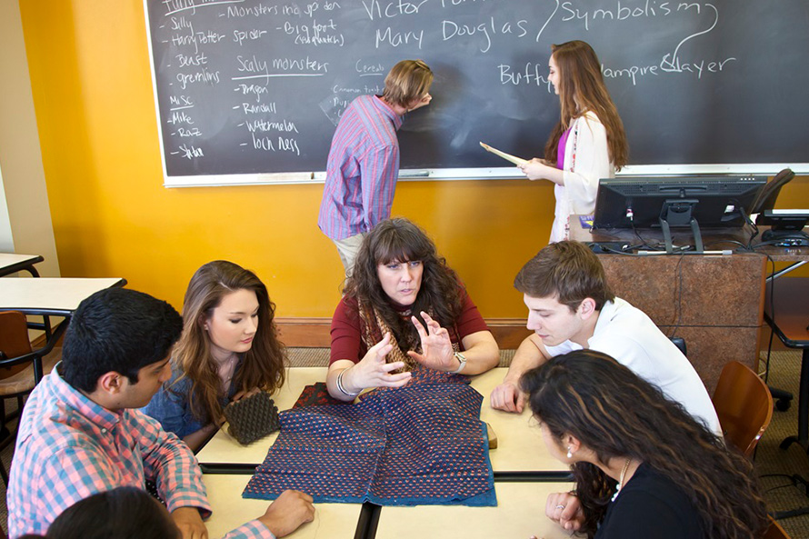 students gather around a lecturer