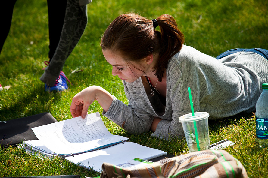student studying on the quad lawn